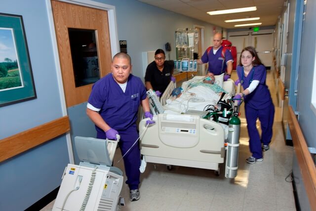 medical professionals transporting a trauma victim on a gurney